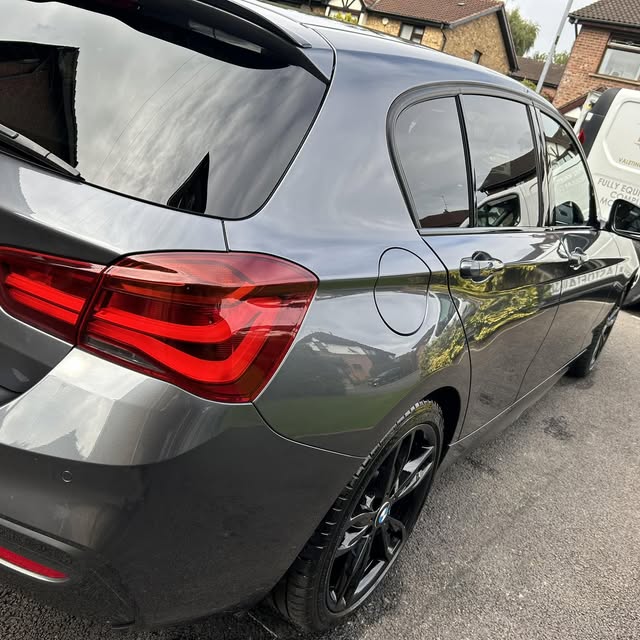 Grey BMW hatchback photographed from the rear-left side.